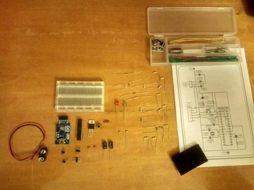 DIY electronics kit for building a custom Arduino-compatible board, featuring a breadboard, electronic components, jumper wires, and a circuit diagram for assembling and programming the board.